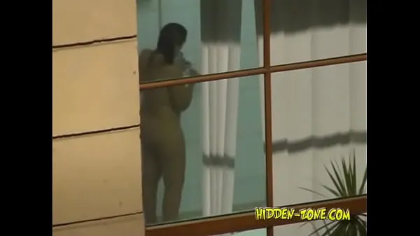 HD A girl washes in the shower, and we see her through the window energy Movies
